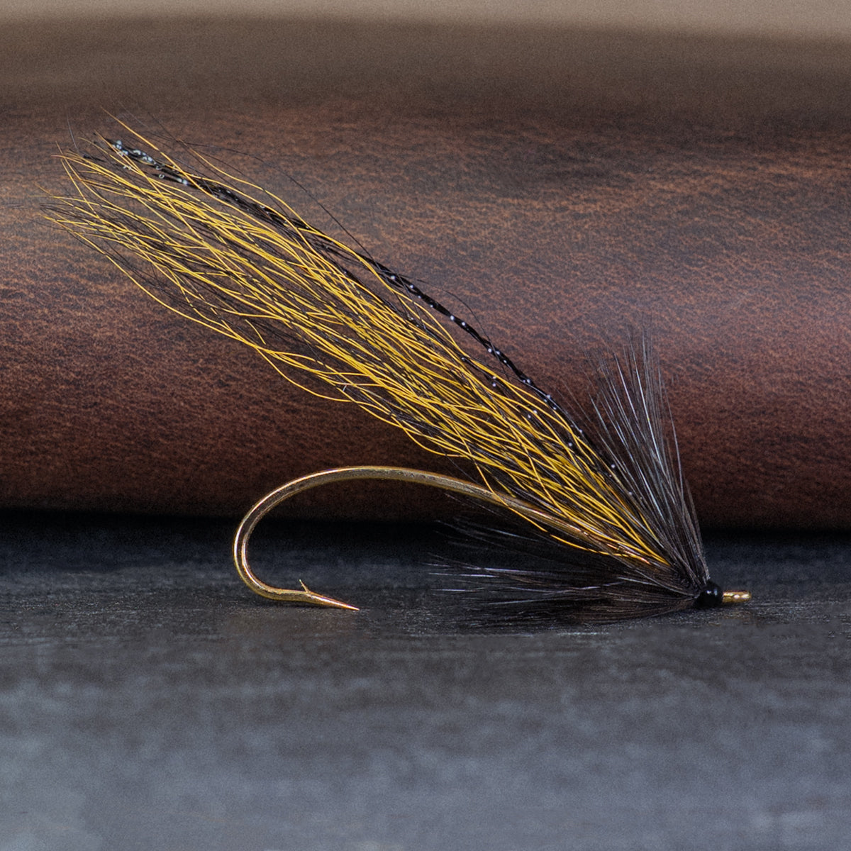 An Atlantic salmon fly named the Golden Killer that is popular on the Kola Peninsula for Atlantic salmon fly fishing, tied here on a gold single hook.