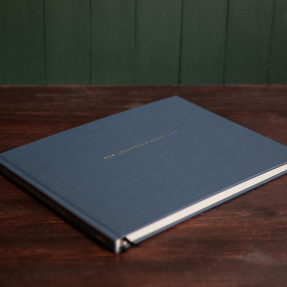 Front cover of the Atlantic Salmon Log on a vintage wooden desk.
