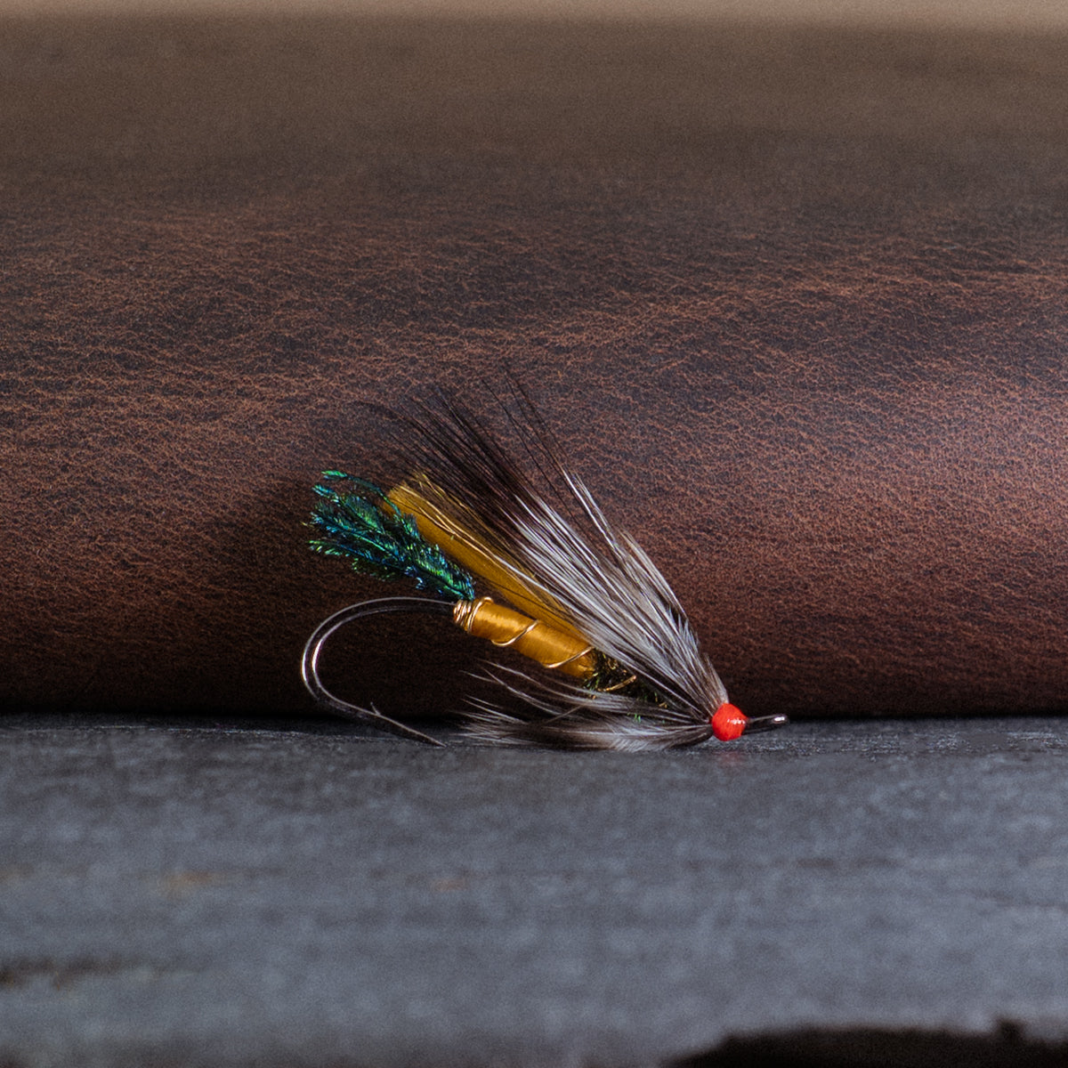 An Atlantic salmon fly named the Rusty Rat that is popular in Québec and Eastern Canada for Atlantic salmon fly fishing, tied here on a single hook.