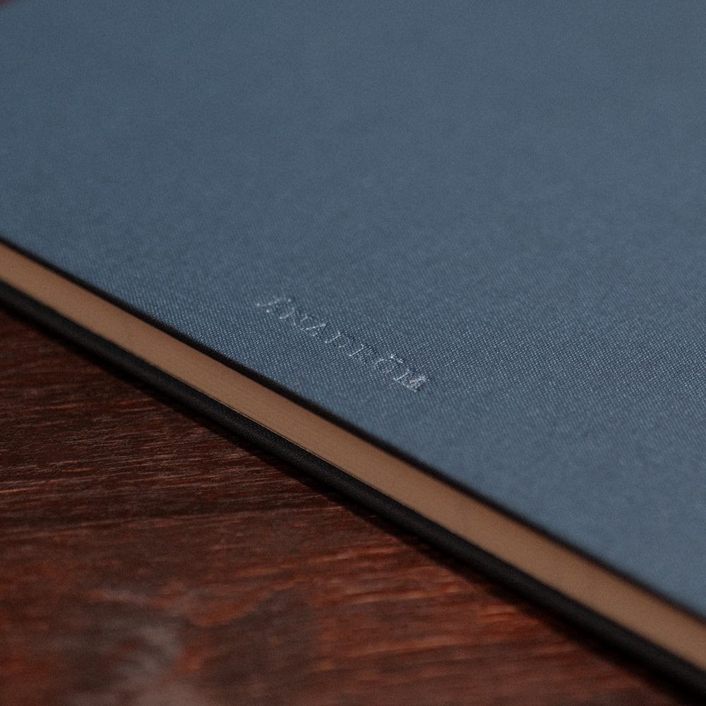 Close up image of the back cover of the Atlantic Salmon Log on a vintage wooden desk.