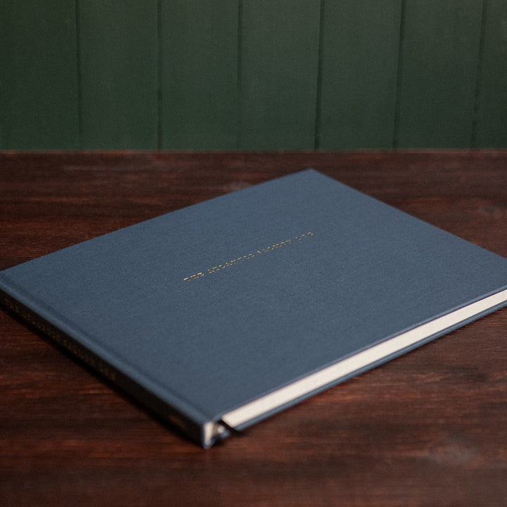 Front cover of the Atlantic Salmon Log on a vintage wooden desk.