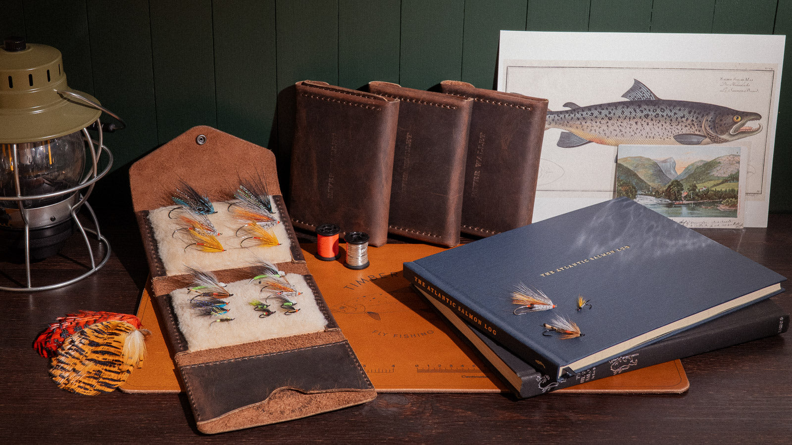 Ánadröm’s full vintage Atlantic salmon collection featuring handcrafted flies, the Atlantic Salmon Log, leather fly wallets, and fly tying mat.