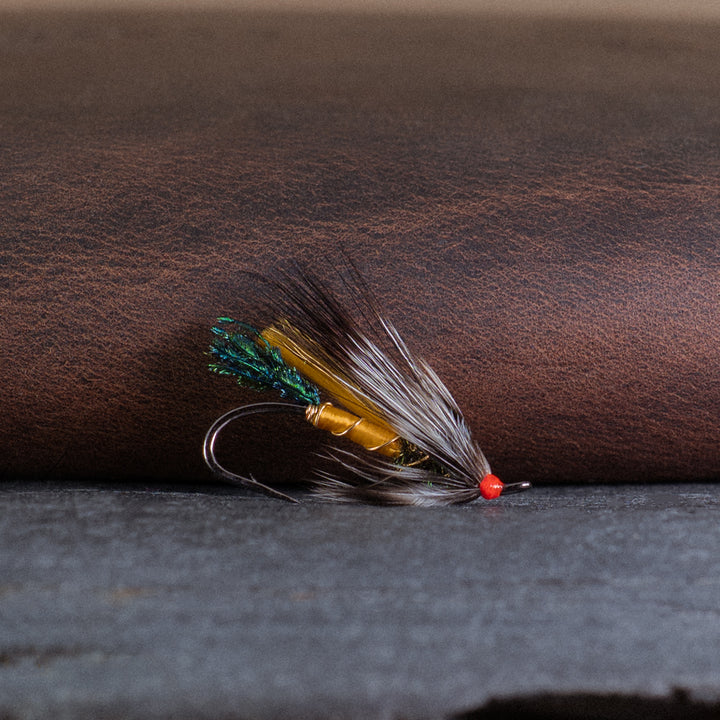 An Atlantic salmon fly named the Rusty Rat that is popular in Québec and Eastern Canada for Atlantic salmon fly fishing, tied here on a single hook.