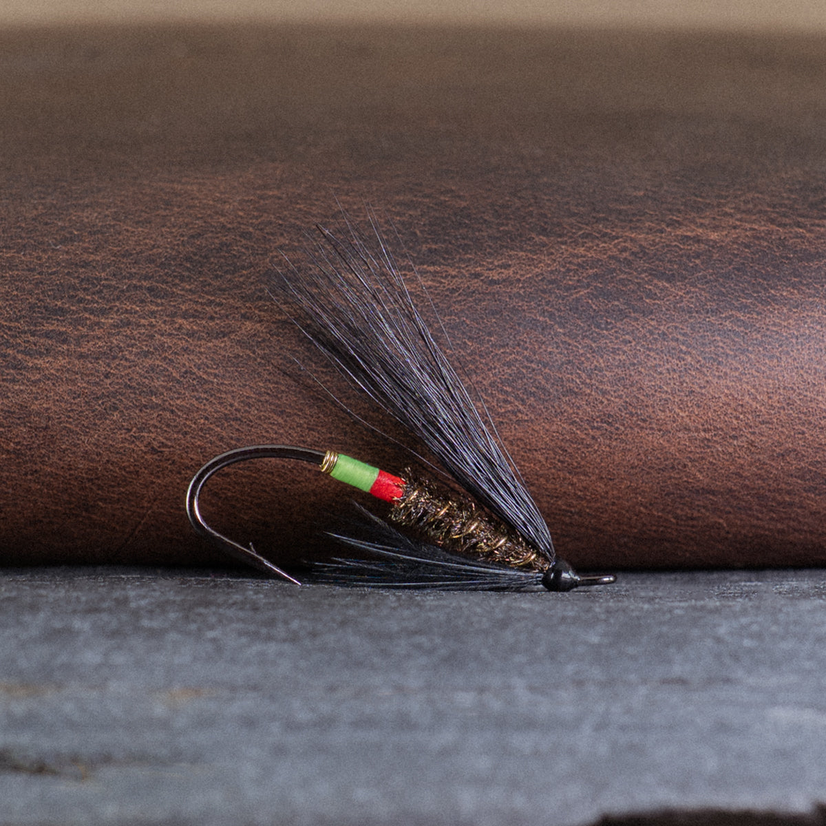 An Atlantic salmon fly named the Undertaker that is popular in Eastern Canada for Atlantic salmon and steelhead fly fishing, tied here on a single hook (#4).