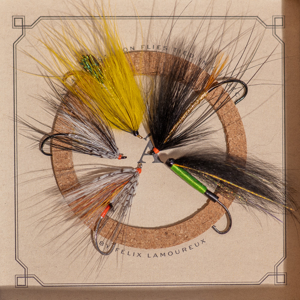 Early Season Essentials box open, showing five flies hand-tied in Quebec on cork insert.