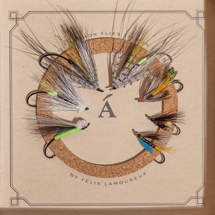 Seven hand-tied Atlantic salmon flies on cork insert, part of Ánadröm's Quebec River Selection box.
